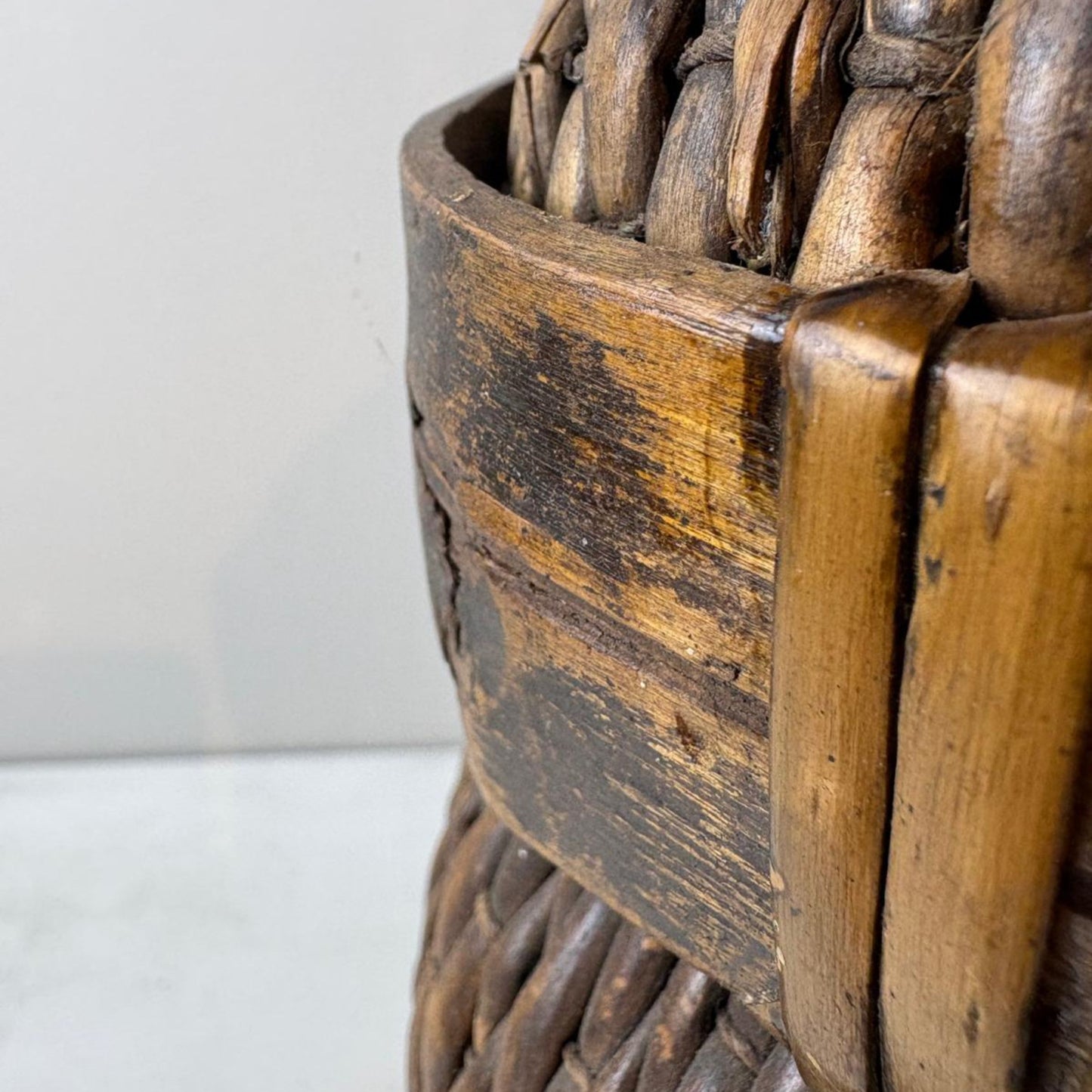 Close-up of a wicker basket with a textured surface on a light background